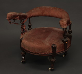 An Edwardian walnut tub back chair, raised on turned supports