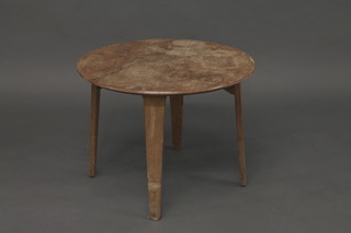 A circular walnut occasional table raised on 4 chamfered supports, the base marked Russell of Broadway 34"