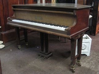 A boudoir grand piano contained in a walnut case by Morley of London