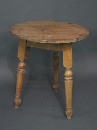 A 19th Century circular pine cricket table, raised on turned supports 27"