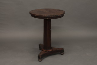A circular William IV mahogany snap top wine table, raised on  a chamfered column with triform base 21"