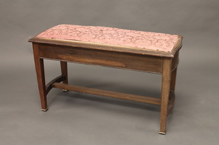 A bleached mahogany duet stool with hinged lid, raised on square tapering supports with H framed stretcher 36"