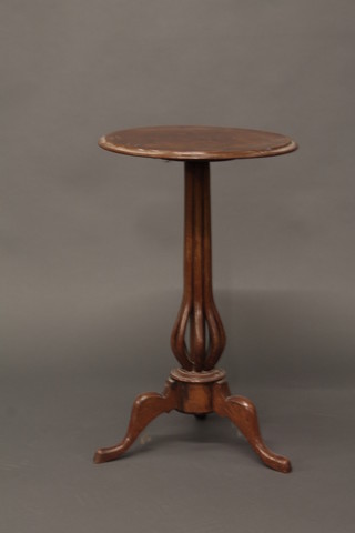 A 19th Century circular walnut wine table raised on a baluster  shaped pierced column and tripod base 17"