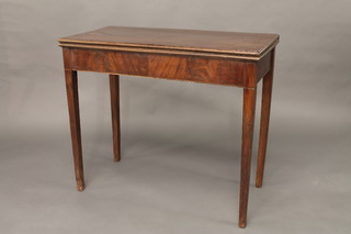 A rectangular Georgian mahogany tea table, raised on square tapering supports 35"