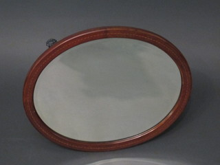 An Edwardian oval bevelled plate wall mirror contained in an inlaid mahogany frame 22"