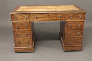 A Victorian oak kneehole pedestal desk fitted 1 long and 8 short drawers with brass handles 47"