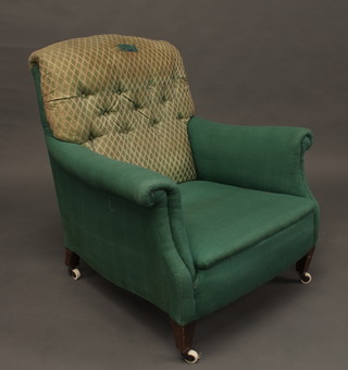 A Victorian mahogany framed armchair upholstered in green buttoned material, raised on square supports
