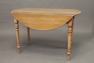 A 19th Century Continental mahogany oval drop flap dining table, fitted a drawer, raised on pillar supports 46"