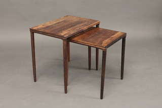 A nest of 2 Danish rosewood rectangular coffee tables on turned supports 22"