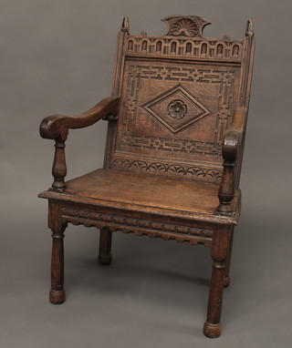 An 18th/19th Century carved oak Wainscot chair raised on turned and block supports  ILLUSTRATED