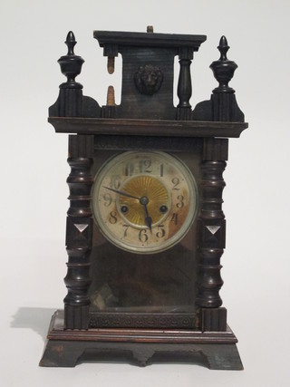 An American striking mantel clock with Arabic numerals  contained in a walnut case