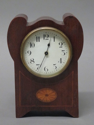 An Edwardian bedroom timepiece with enamelled dial and Arabic numerals contained in a shaped inlaid mahogany case   ILLUSTRATED