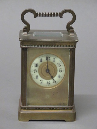 A French 19th Century carriage clock with enamelled dial and Arabic numerals contained in a gilt case   ILLUSTRATED