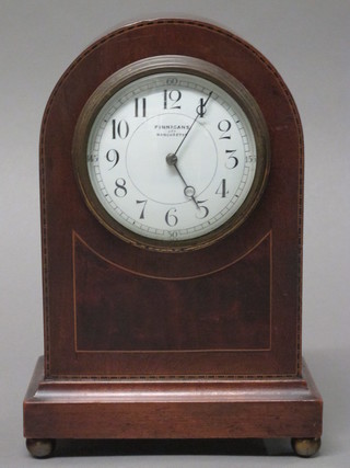 A bedroom timepiece with enamelled dial and Arabic numerals contained in an arched inlaid mahogany case by Finnigans
