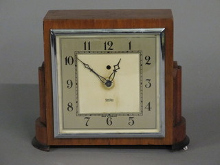 An Art Deco Smiths electric mantel clock with square painted dial and Arabic numerals contained in a walnut case