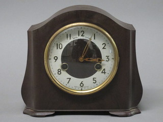 An Art Deco striking mantel clock with silvered chapter ring and  Arabic numerals contained in an arched brown Bakelite case