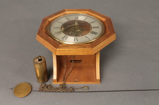 A Postman's alarm clock with silvered chapter ring and Roman  numerals contained in an oak case 12", f,