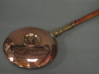 A 19th Century copper warming pan with turned fruitwood  handle