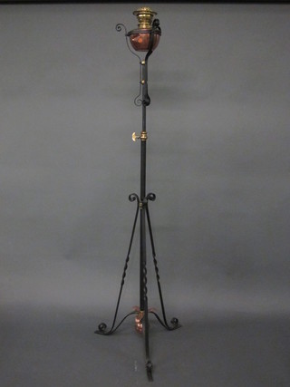 A Victorian wrought iron and copper adjustable oil lamp