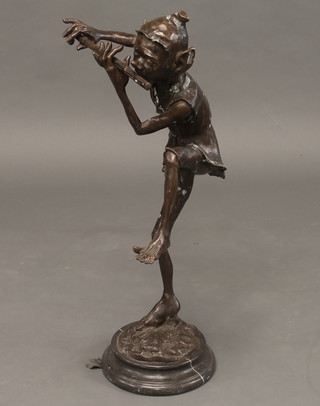 A bronze figure of a flute playing elf, raised on a black marble base 32"