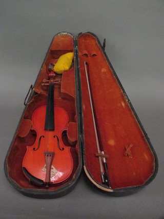 A childs violin labelled JTL, complete with bow, contained in a  wooden carrying case