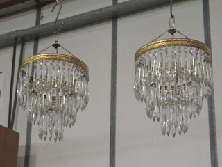 A pair of circular graduated light fittings with cut glass lozenges