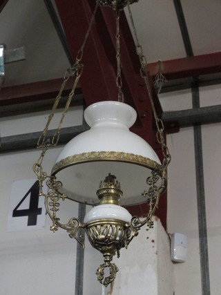 A Victorian style gilt metal and opaque glass hanging oil lamp  with glass shade, cracked,