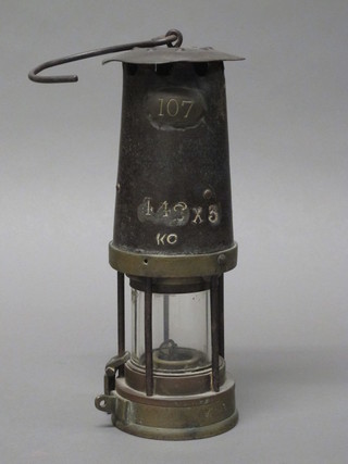 A miner's safety lamp marked 107