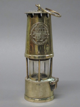 A brass miner's safety lamp by the Protector Lamp and Lighting  Co.