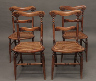 A set of 4 Victorian carved walnut bedroom chairs with shaped  mid rails and woven cane seats, raised on turned supports