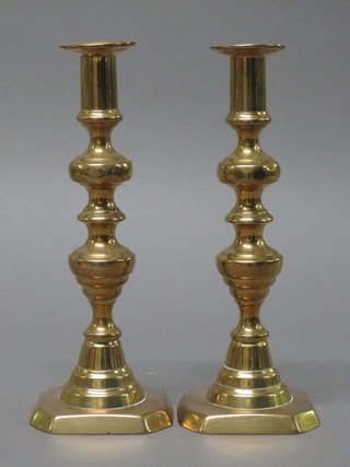 A pair of 19th Century brass candlesticks with ejectors 10"