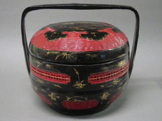 A circular Oriental lacquered 3 section food carrier 14"
