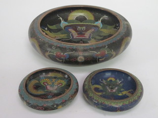 A circular cloisonne enamelled bowl decorated a dragon 11" and  a pair of cloisonne bowls decorated dragons 5"