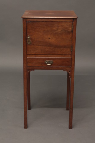 A rectangular Georgian mahogany bedside cabinet fitted a  cupboard above a drawer, raised on square tapering supports 13"