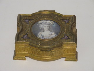 A 19th Century Continental shaped gilt metal box the lid set a portrait miniature of a lady, raised on bracket feet 5"   ILLUSTRATED