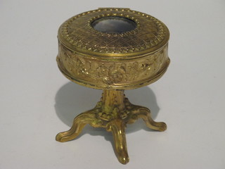 A circular Continental gilt metal trinket box the lid decorated a portrait of a lady, raised on a tripod base, marked Depose 5"   ILLUSTRATED