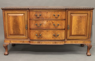 An Edwardian Chippendale style mahogany sideboard with  gadrooned decoration fitted 3 long drawers flanked by a pair of  cupboards, raised on cabriole supports 72"