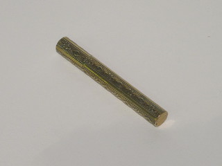 A Victorian brass needle case containing a small collection of  needles