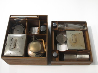 A 1920's 20 piece travelling picnic set comprising Primus stove, kettle, 3 square sandwich boxes, 4 rectangular enamelled plates,  2 cups and saucers, 2 silver plated beakers, 4 glass bottles, a  circular sugar bowl