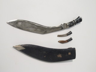A Kukri with leather scabbard and skinning knives
