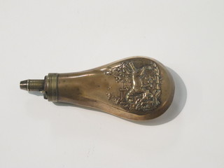 An embossed brass shot flask