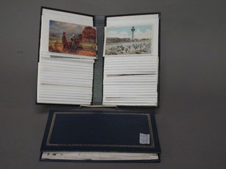 A black loose leaf album of 40 postcards and a blue loose leaf  album of 40 postcards