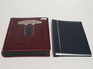 A blue album containing approx 36 postcards and a red album  containing approx 112 various postcards