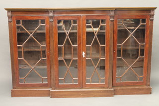 A Georgian style mahogany breakfront library bookcase, fitted adjustable shelves enclosed by astragal glazed panelled doors,  raised on a platform base 72"
