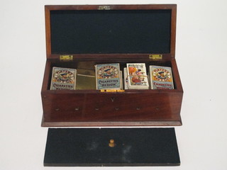 A collection of cigarette cards contained in a rectangular  mahogany box with hinged lid