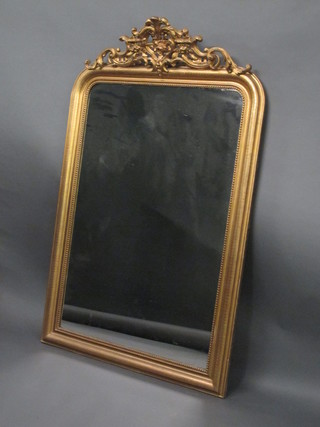 A 19th Century arched plate mirror contained in a decorative gilt frame 39"  ILLUSTRATED