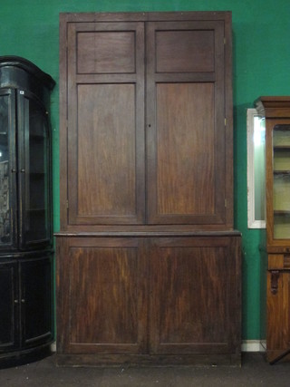 A 19th Century mahogany estate cabinet, the upper section fitted shelves and 6 short drawers and 2 long drawers, the base fitted a  cupboard enclosed by panelled doors, raised on a platform base  54"