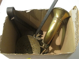 A brass taxi horn, a metal safe plate, a chestnut roaster and an iron pot hanger