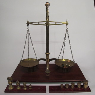 A pair of brass pan scales and a collection of weights by G  Stevens & Sons
