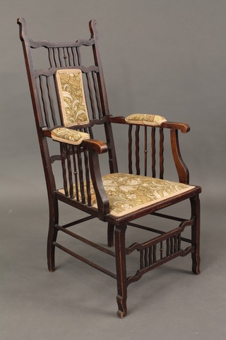 An Arts & Crafts mahogany stick and rail back carver chair